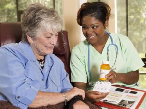 a nurse with medications for an older woman