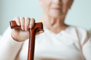 fall prevention image - closeup of a woman holding a wooden cane